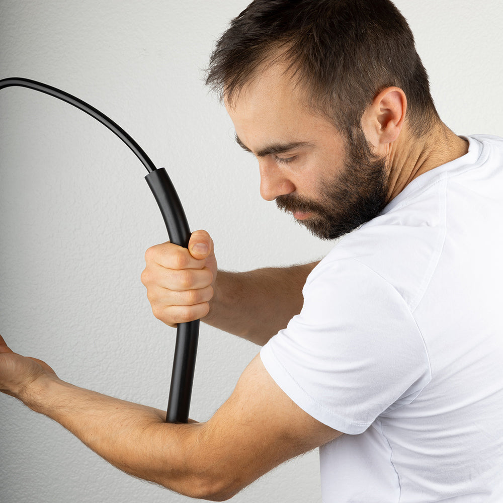 A person using Theratsu to relieve tension in their forearm.				