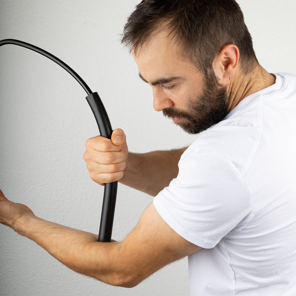 A person using Theratsu to relieve tension in their forearm.